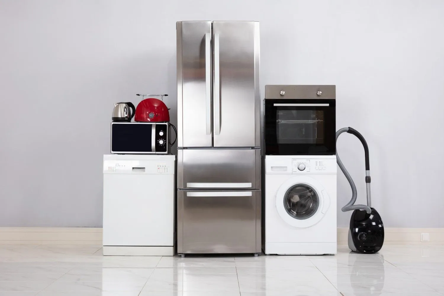 Fridge, oven, washer, dishwasher and small appliances lined up in a bright room