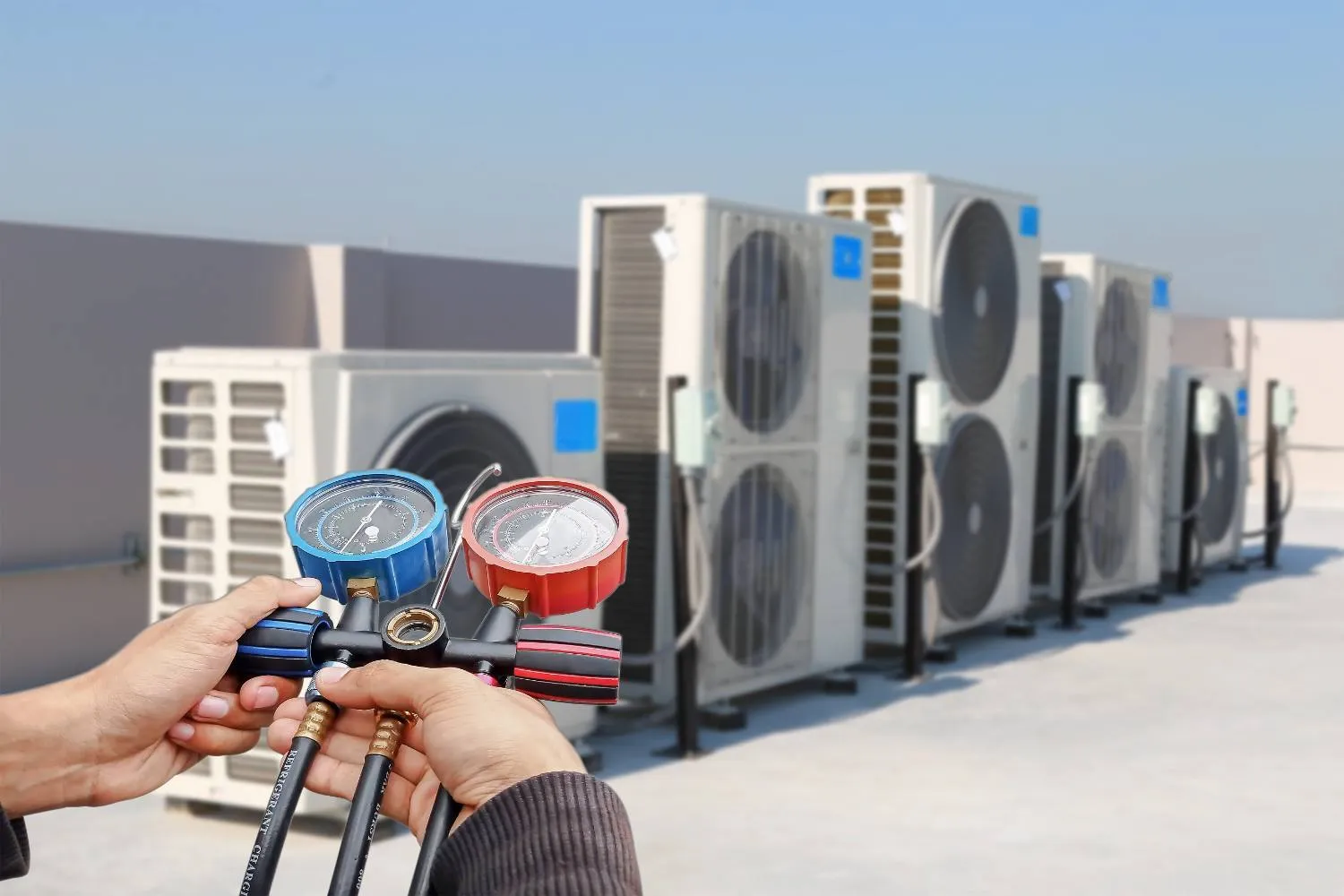 Pressure gauges checking a row of outdoor cooling units