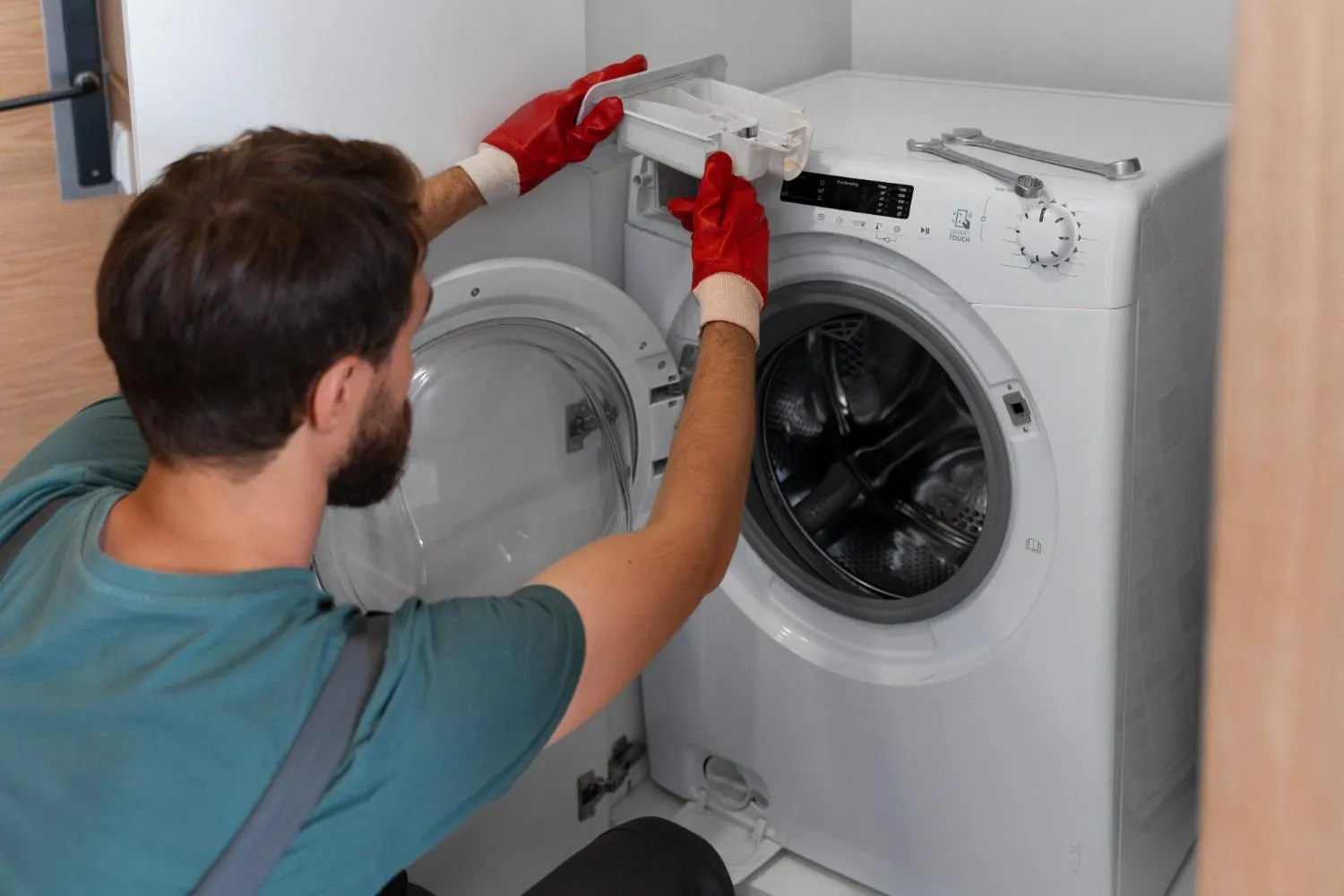 Technician working on a front-load washing machine